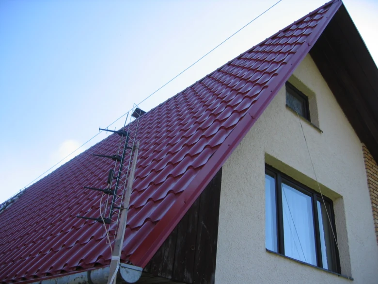Střecha s červenými taškami a viditelným sklonem