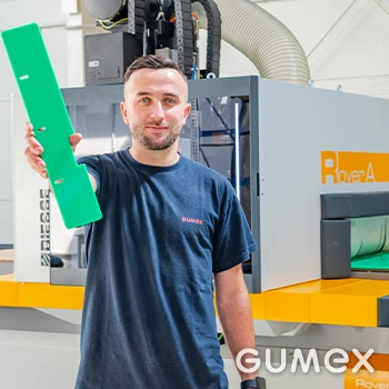 Man holding green plastic part