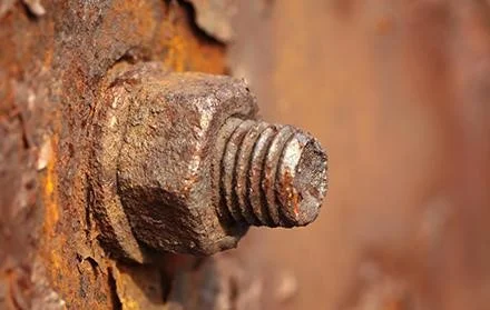 Rusty bolt and nut on old rusty iron plate.