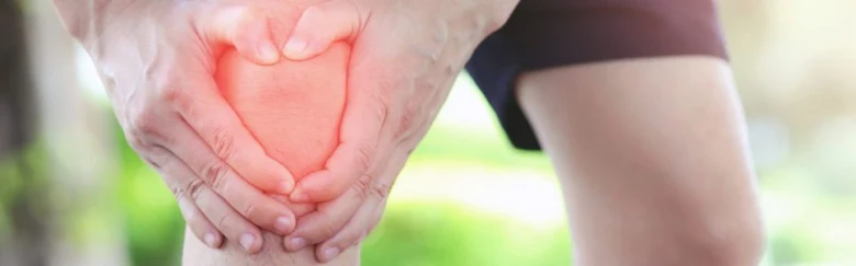 Person holding knee in pain