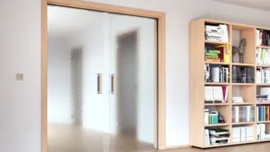 Moderní posuvné dveře s matným sklem v dřevěném rámu.