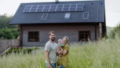 Family with solar panels on house